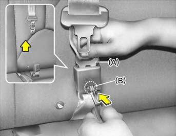 To disconnect the metal tab (A) from the buckle (B), insert a narrow-ended tool