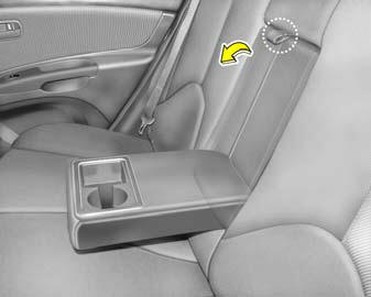 The rear drink holder is located in the rear seat armrest for holding cups or