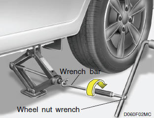 After inserting a wrench bar into the wheel nut wrench, install the wrench bar