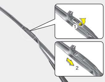 2. Lift up the wiper blade clip. Then pull down the blade assembly and remove